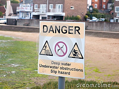 White and yellow dock danger sign warning deep water Stock Photo