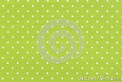 White dot over yellow polka dot fabric background and texture. Stock Photo