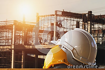 white and yellow safety helmet in construction site Stock Photo
