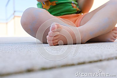 White young girl child feet on a rough stone ground Stock Photo