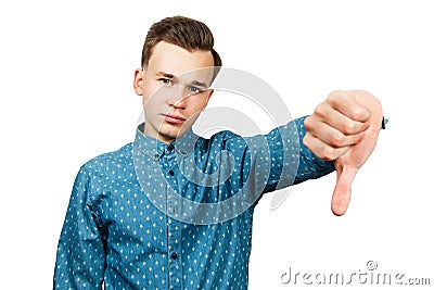 White young man dressed in blue shirt showing thumbs down. Isolated on a white background Stock Photo