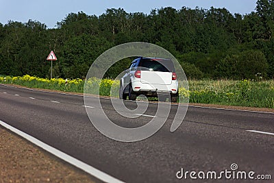 White youth car parked by the side of the road during a travel picnic. Outdoor weekends, local travel Stock Photo