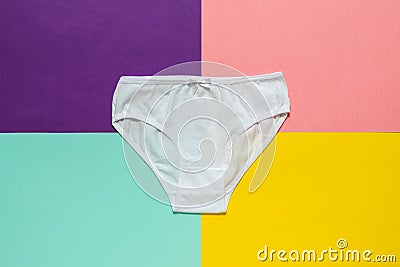 White youth panties on a multicolored background. Flat lay. Stock Photo