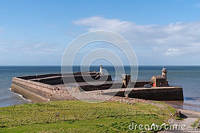 Whitehaven Cumbria UK The West Pier Lighthouse and harbour wall Stock Photo