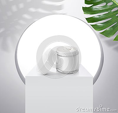 Whitening cream in a glistening white spherical base packaging. with light shining through windows and tropical plants, for Editorial Stock Photo