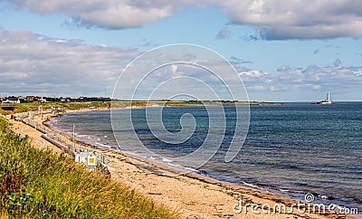 Whitley Bay beach and a lighthouse in a background in a summer day, England Editorial Stock Photo