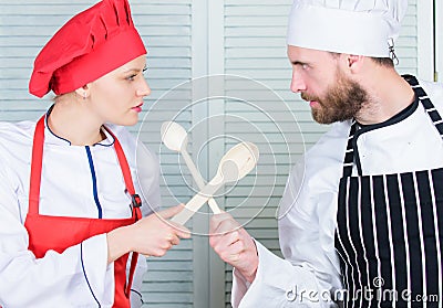 Who cook better. Ultimate cooking challenge. Culinary battle of two chefs. Couple compete in culinary arts. Kitchen Stock Photo