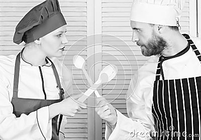 Who cook better. Ultimate cooking challenge. Culinary battle of two chefs. Couple compete in culinary arts. Kitchen Stock Photo