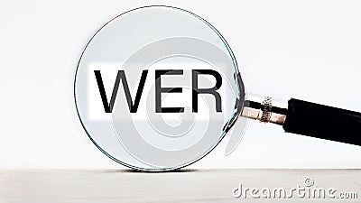 Who, German word for Who, (German: Wer) lettering on through a magnifying glass on a light background Stock Photo