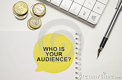 WHO IS YOUR AUDIENCE on yellow sticker on pen with coin Stock Photo