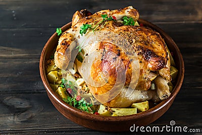 Whole baked chicken with mushrooms and potatoes in a baking dish on a table. Baked turkey. Christmas dish. Easter Stock Photo