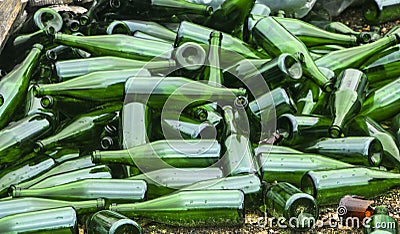 Whole and broken green bottles, lie mountain on pavement. Concept: waste recycling, disposal of garbage and glass objects Stock Photo