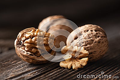 Whole and cracked walnuts with kernels Stock Photo