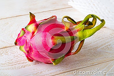 Whole dragon fruit or pitaya on a white wooden table. Fruits and vegetables. Healthy vegetarian food rich in B vitamins and tannin Stock Photo