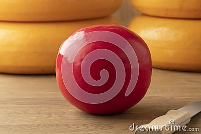Whole Dutch red Edam cheese and large cheeses at the background Stock Photo