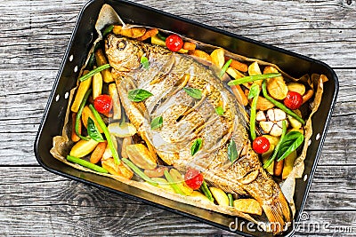 Whole fish baked in a baking dish, top view Stock Photo