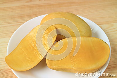 Whole Fruit and Cut in Half Aromatic Tasty Ripe Ok-Rong Mangoes of Thailand Stock Photo