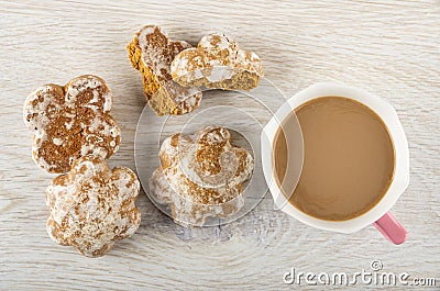 Whole gingerbreads, broken gingerbread, cup of coffee with milk on table. Top view Stock Photo