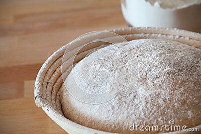 Whole-grain dough proofing in a baneton basket Stock Photo