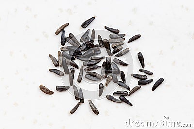 Whole-grain niger seeds close up on gray Stock Photo