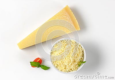 Whole and grated parmesan cheese Stock Photo