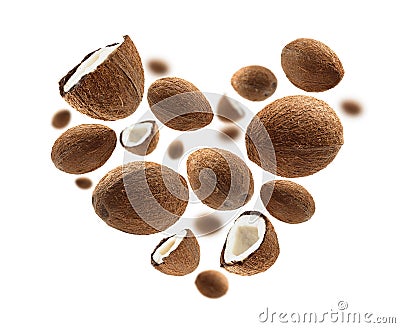 Whole and half cocoanuts in the shape of a heart on a white background Stock Photo