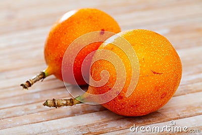 Whole and half fruits fresh granadilla on wooden table Stock Photo