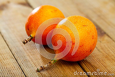 Whole and half fruits fresh granadilla on wooden table Stock Photo