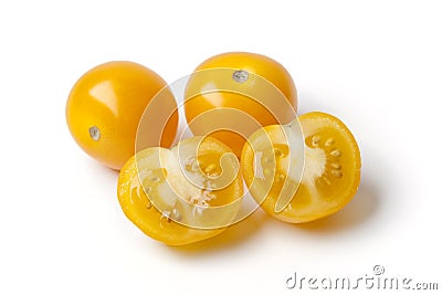 Whole and half yellow tomatoes Stock Photo