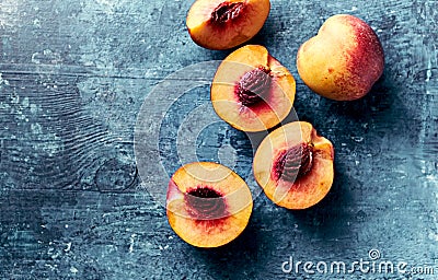Whole and halved nectarines on rustic painted background Stock Photo