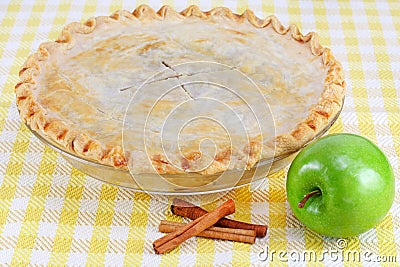 Whole Homemade Apple Pie with Cinnamon Sticks Stock Photo