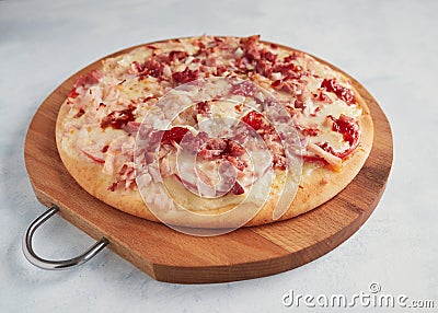 Whole homemade pizza on a wooden board Stock Photo