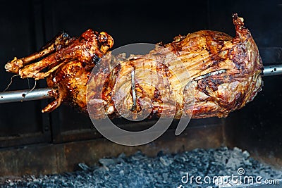 Whole lamb baked on a spit Stock Photo