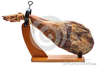 Whole leg of Spanish Iberian serrano ham in wooden support jamoneror. Stock Photo