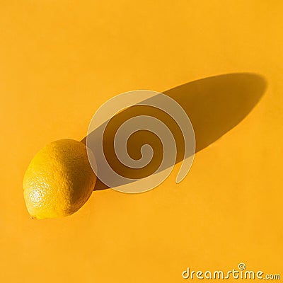 Whole lemon on a yellow paper background Stock Photo