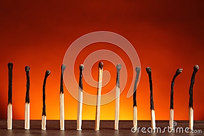 Whole match among burnt ones on table. Uniqueness and difference concept Stock Photo