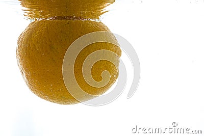 A whole orange thrown into the water. View from under the water Stock Photo