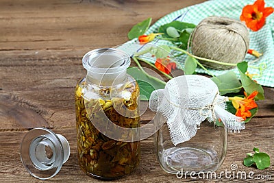 Making tincture from Tropaeolum majus, also called garden nasturtium or Indian cress Stock Photo