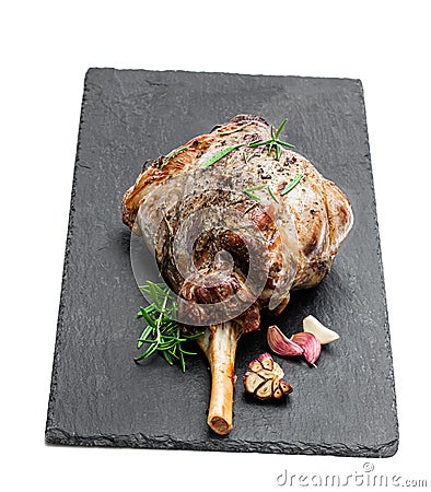 Whole roast lamb leg on black stone background Stock Photo