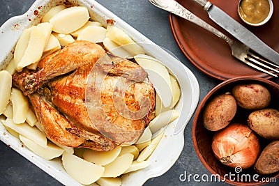 Whole roasted chicken with golden crust garnished potato Stock Photo