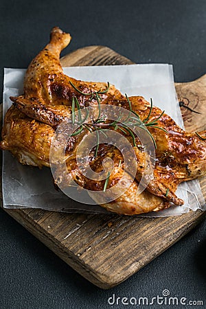 Whole roasted chicken rosemary. grilled barbecue delicious food on dining table at holiday celebrate Stock Photo