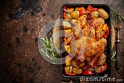 Whole roasted chicken or turkey with pumpkin, potatoes, red pepper and rosemary. Stock Photo