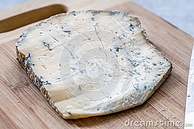 Whole Roquefort French Blue Cheese with Knife on Wooden Board Stock Photo