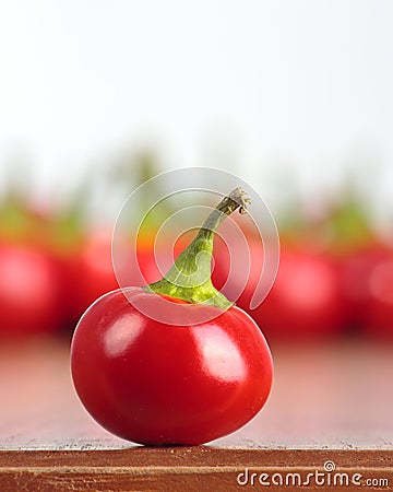 Whole round hot chilly pepper on a table Stock Photo