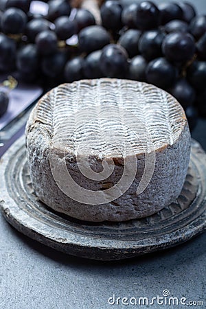 Whole round mature French Tomme cheese close up Stock Photo