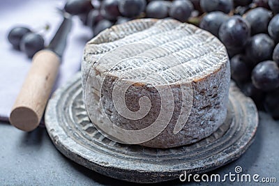 Whole round mature French Tomme cheese close up Stock Photo