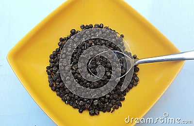 Whole spice black peppers in a bowl. Stock Photo