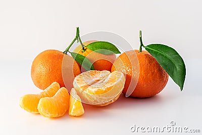 Whole tangerines or mandarines orange fruits and peeled segments Stock Photo