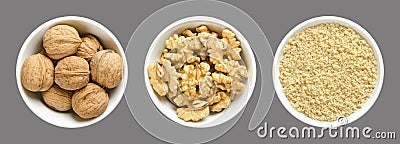 Whole, walnuts, kernel halves and ground walnuts in white bowls on gray background Stock Photo