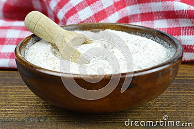 Whole wheat flour in wooden bowl Stock Photo